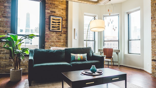 apartment living room with dark green couch